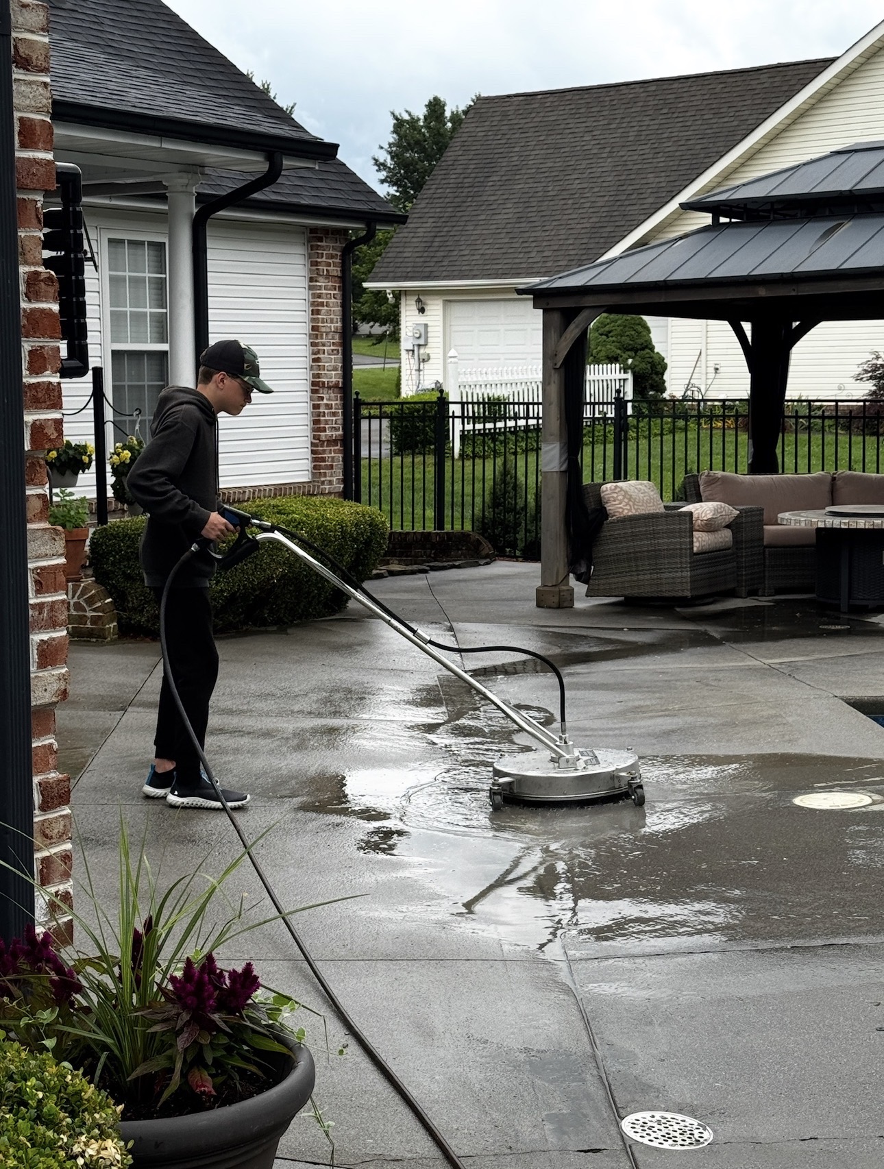 Pressure washing pool deck close view